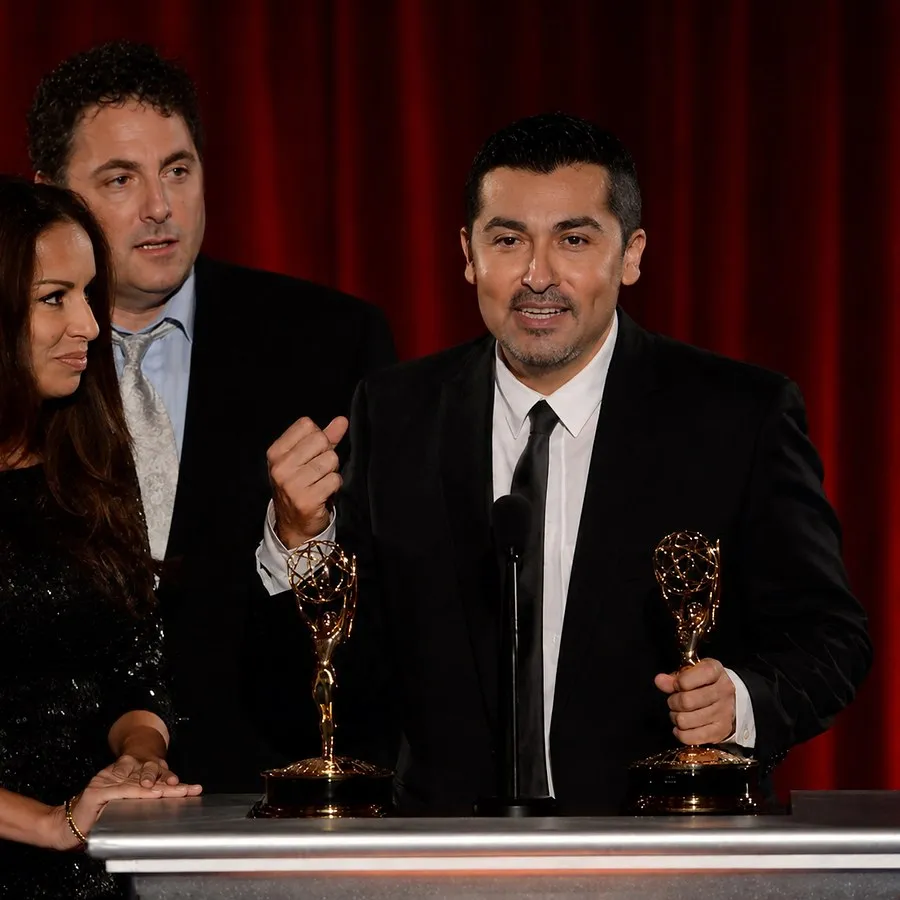 Accepting an Emmy award on stage